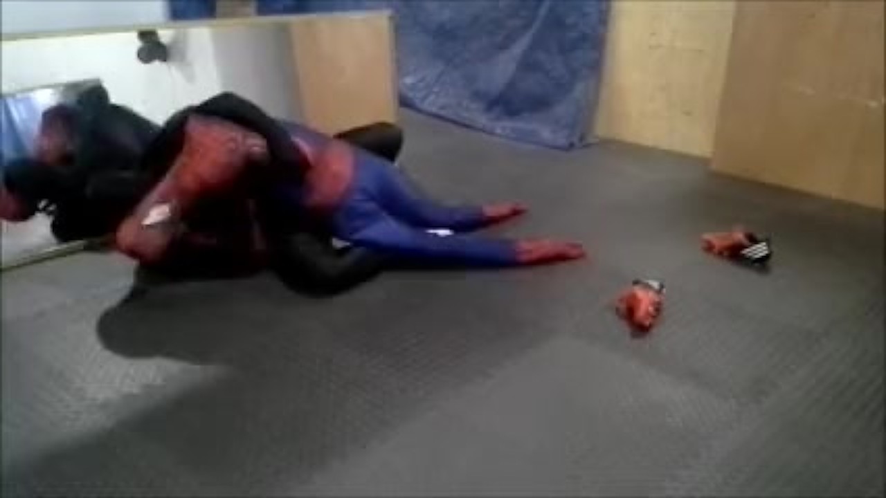 black sex drone playing with his spiderman dummy