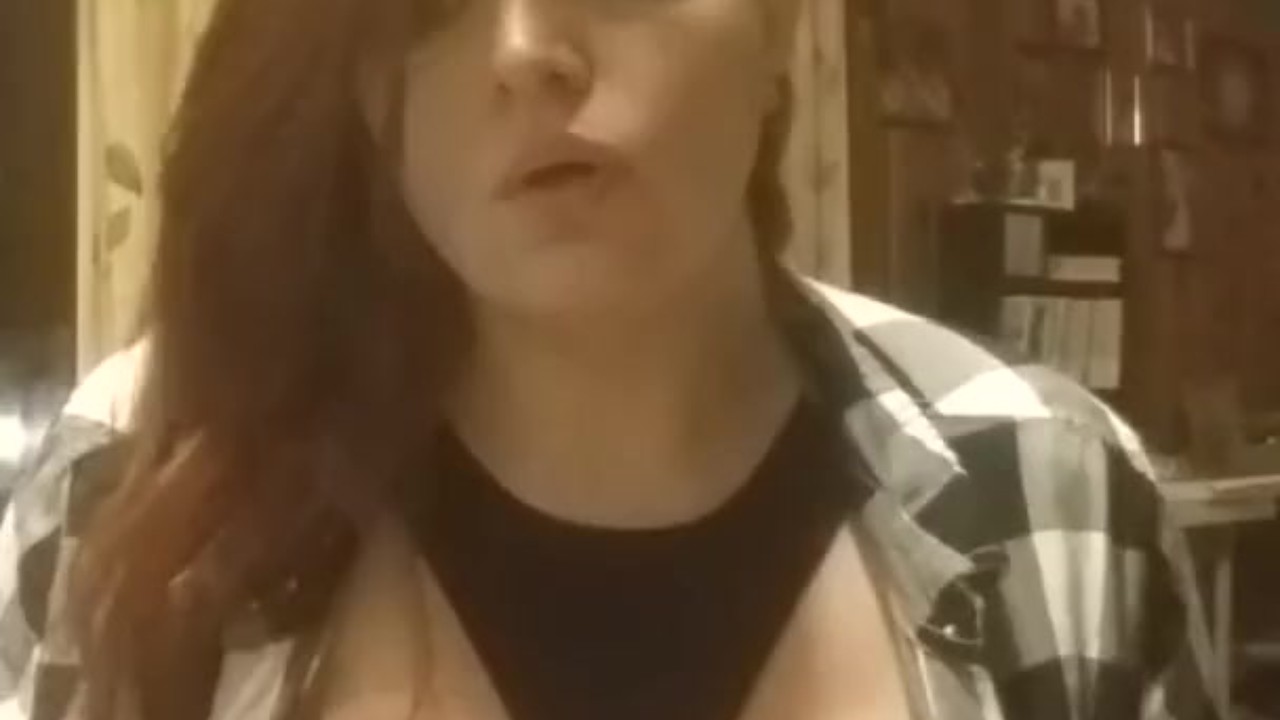 Sexy redhead smoking with tits out fetish play