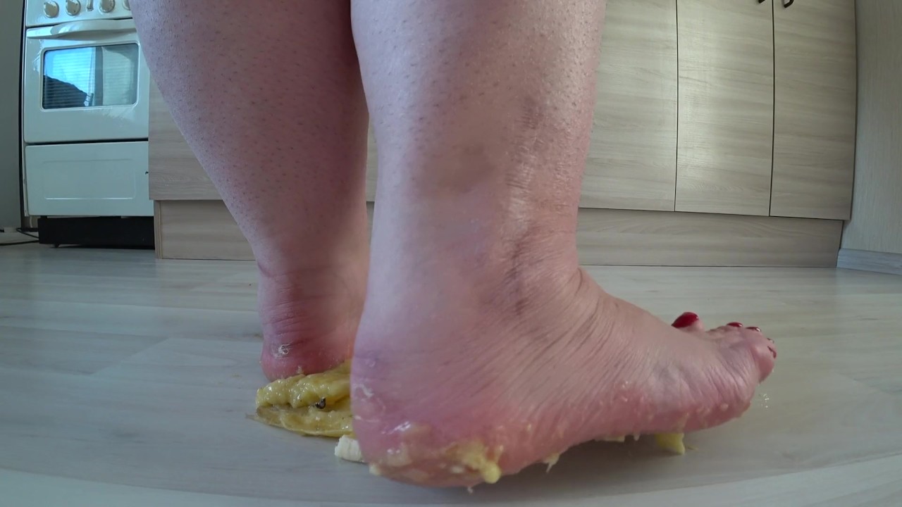 a big mature woman, bbw, smash a banana with bare feet, heels. crash trampl
