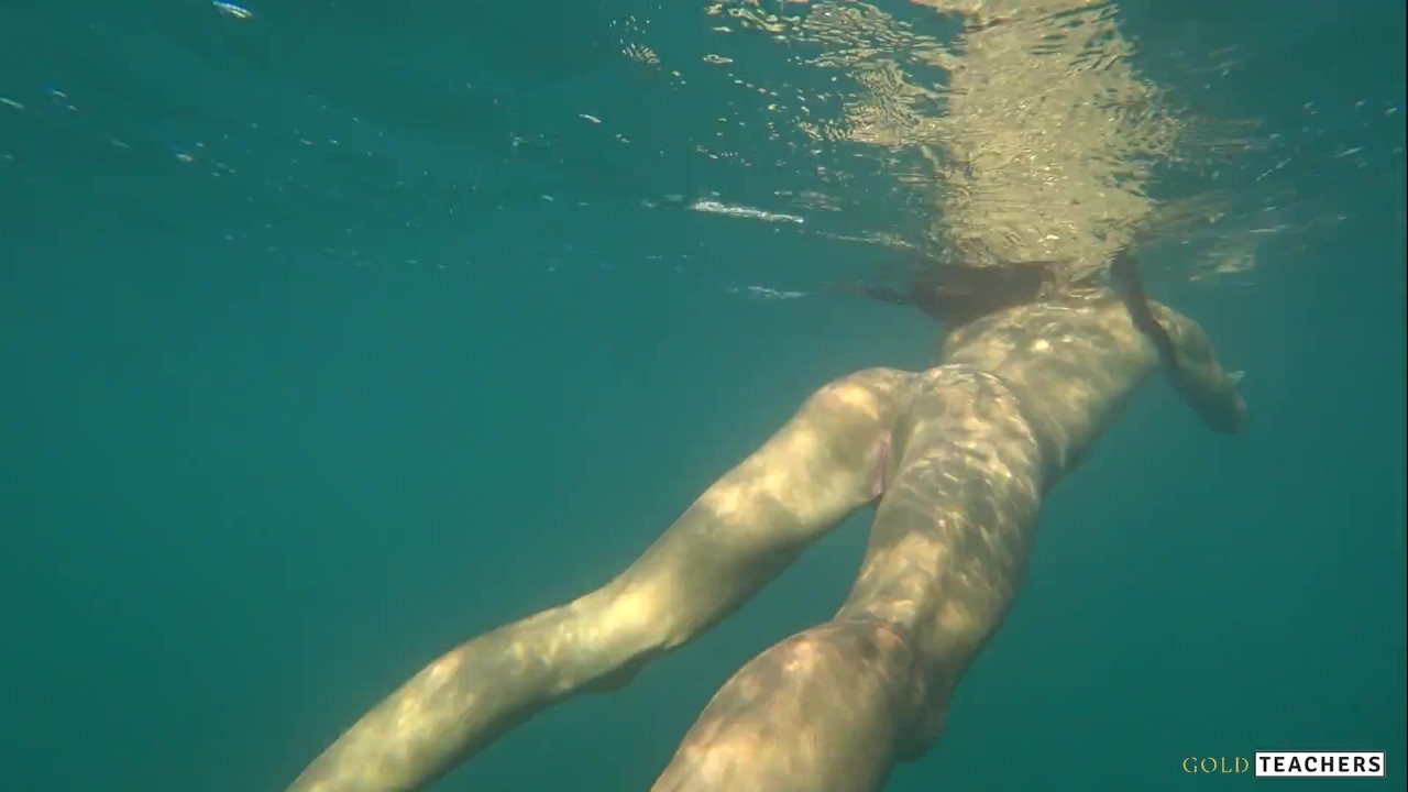 Nude model swims on a public beach in Russia