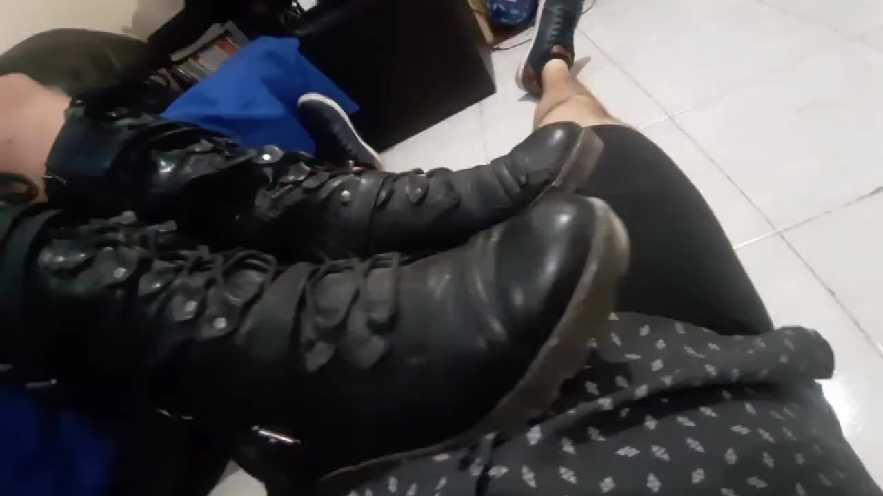 New girl in boots talking to slave &amp; resting her feet on cock
