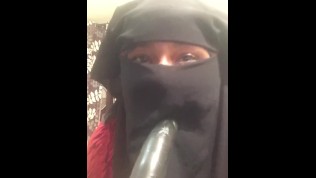 Lonely Niqabi Hijabi woman sucking dildo & shaking ass