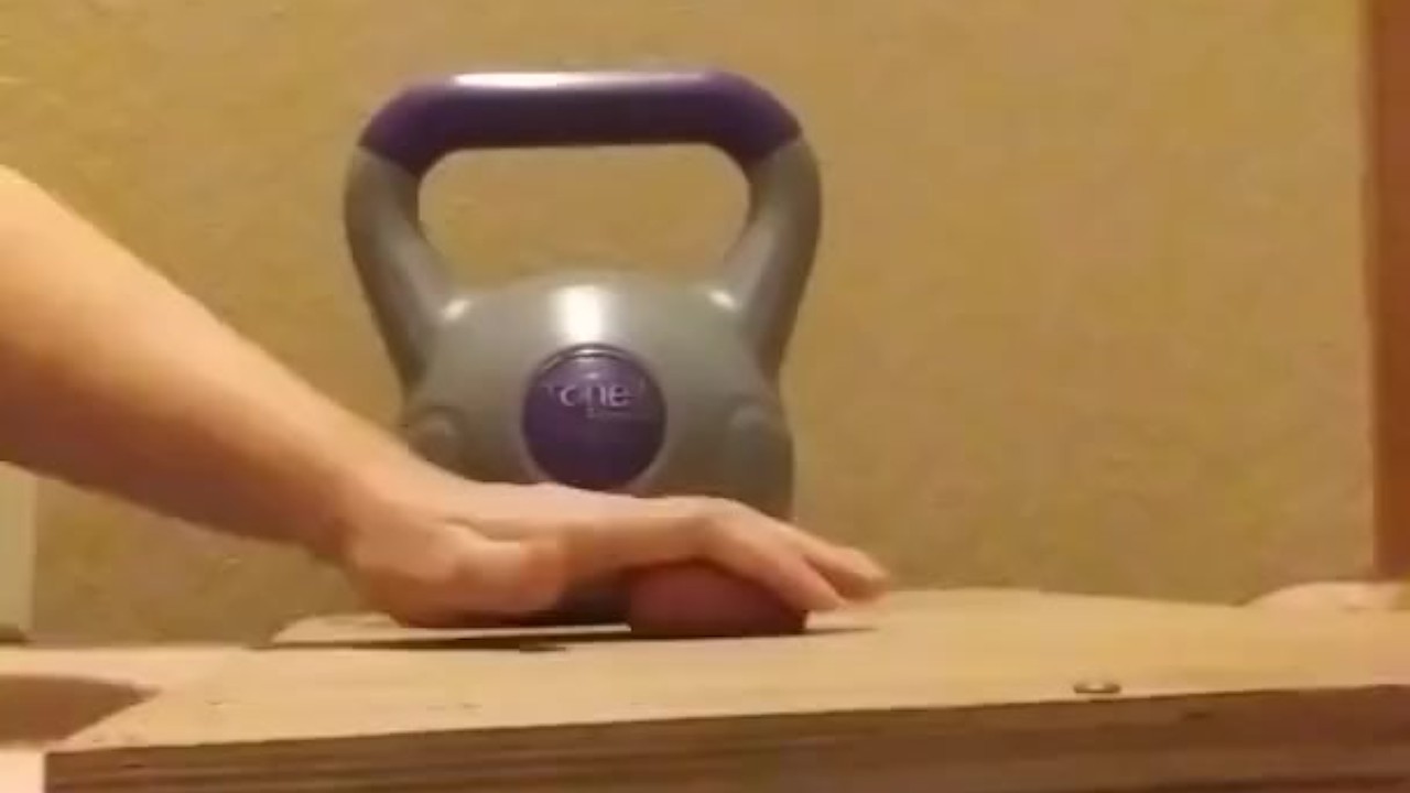 Wife crushes balls with kettle bells